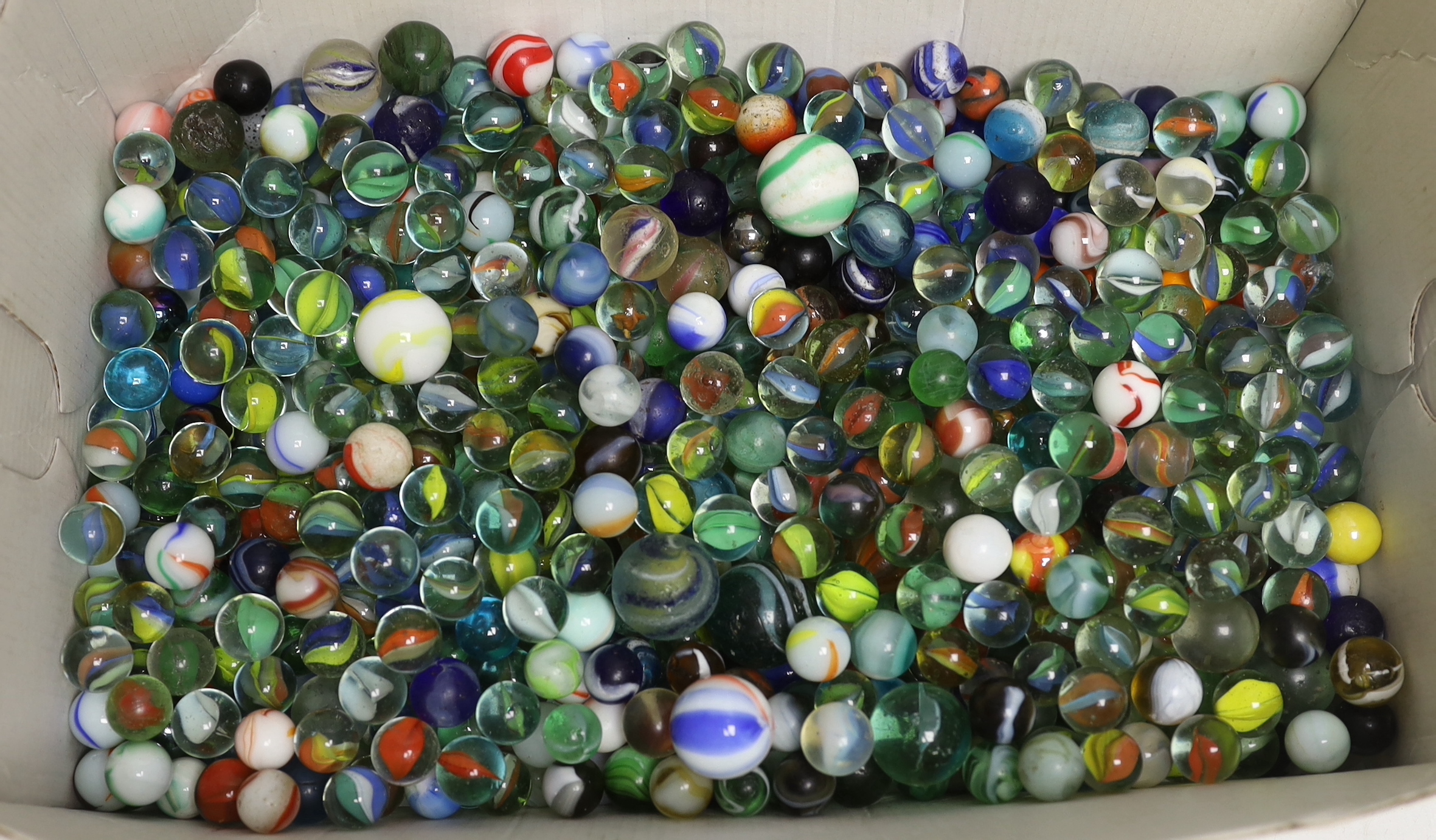 A solitaire board and a large collection marbles